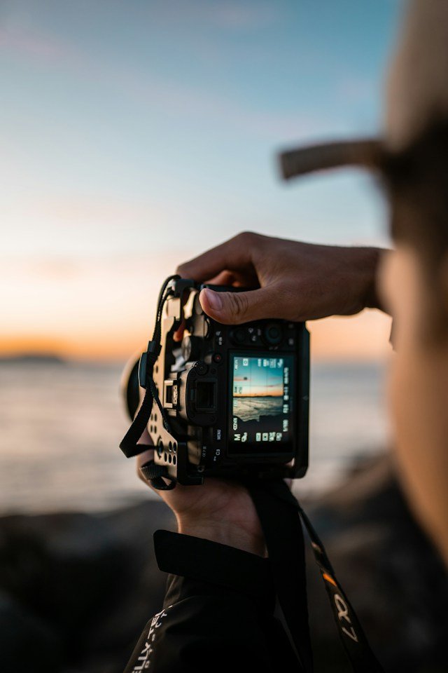 Professional photographer capturing brand imagery on set